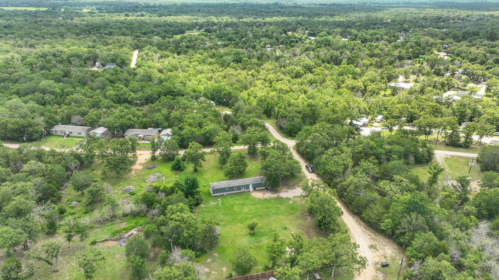 103 Sunset Lane Somerville, TX 77879 - Photo 30 of 42 an aerial view of residential houses with outdoor space and trees