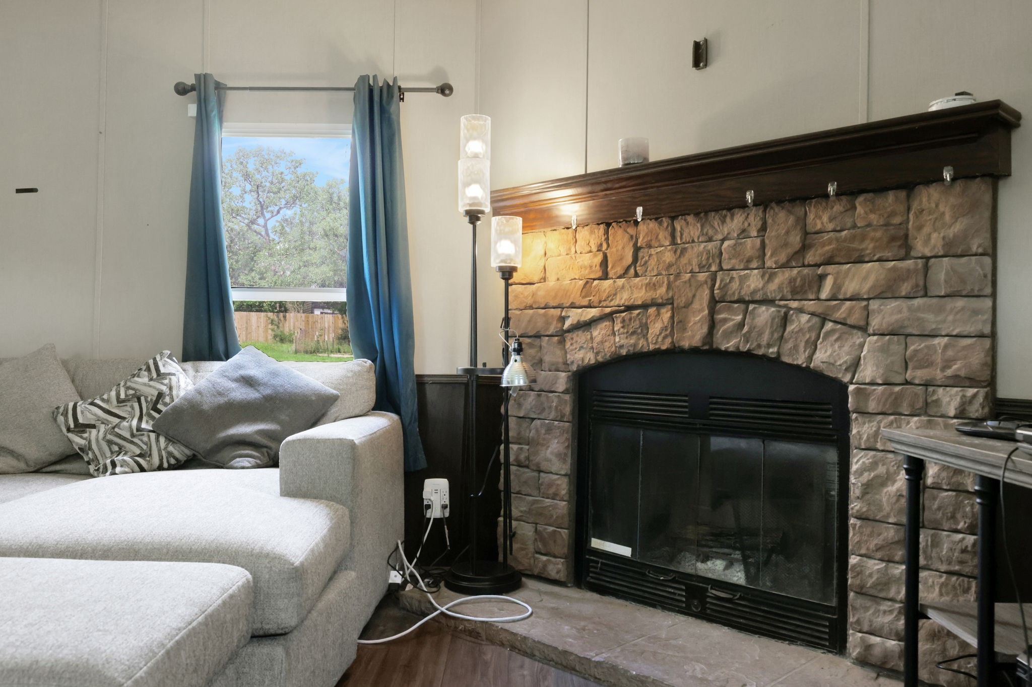 103 Sunset Lane Somerville, TX 77879 - Photo 3 of 42 a living room with furniture a fireplace and a floor to ceiling window