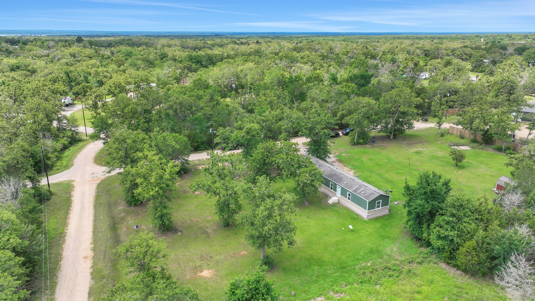 103 Sunset Lane Somerville, TX 77879 - Photo 33 of 43 a view of a green yard with large trees