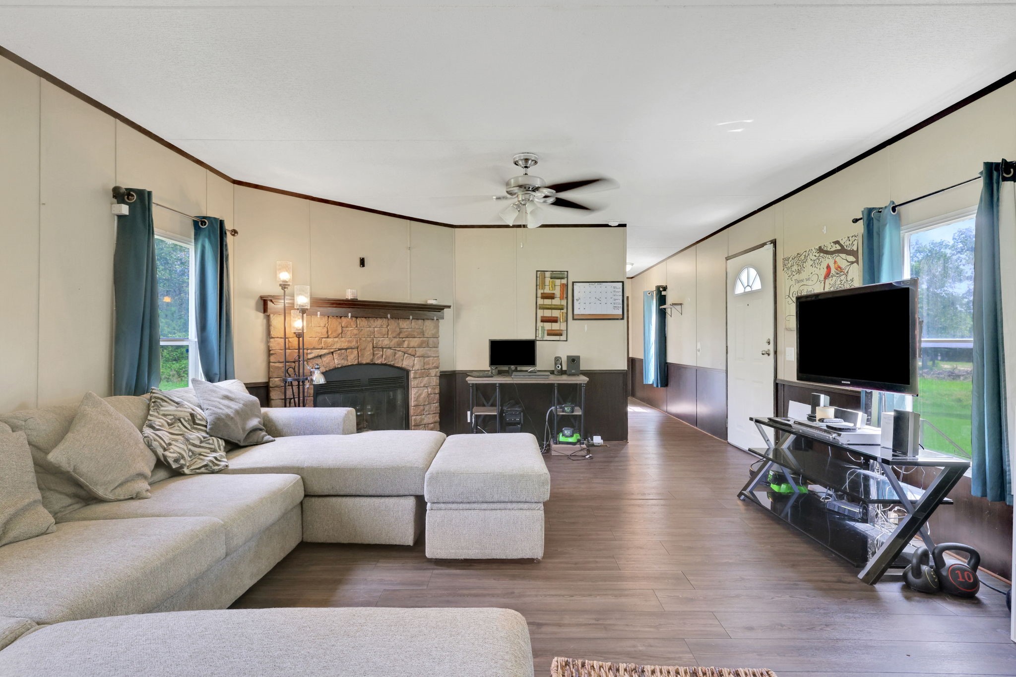 103 Sunset Lane Somerville, TX 77879 - Photo 5 of 43 a living room with furniture a flat screen tv and a fireplace