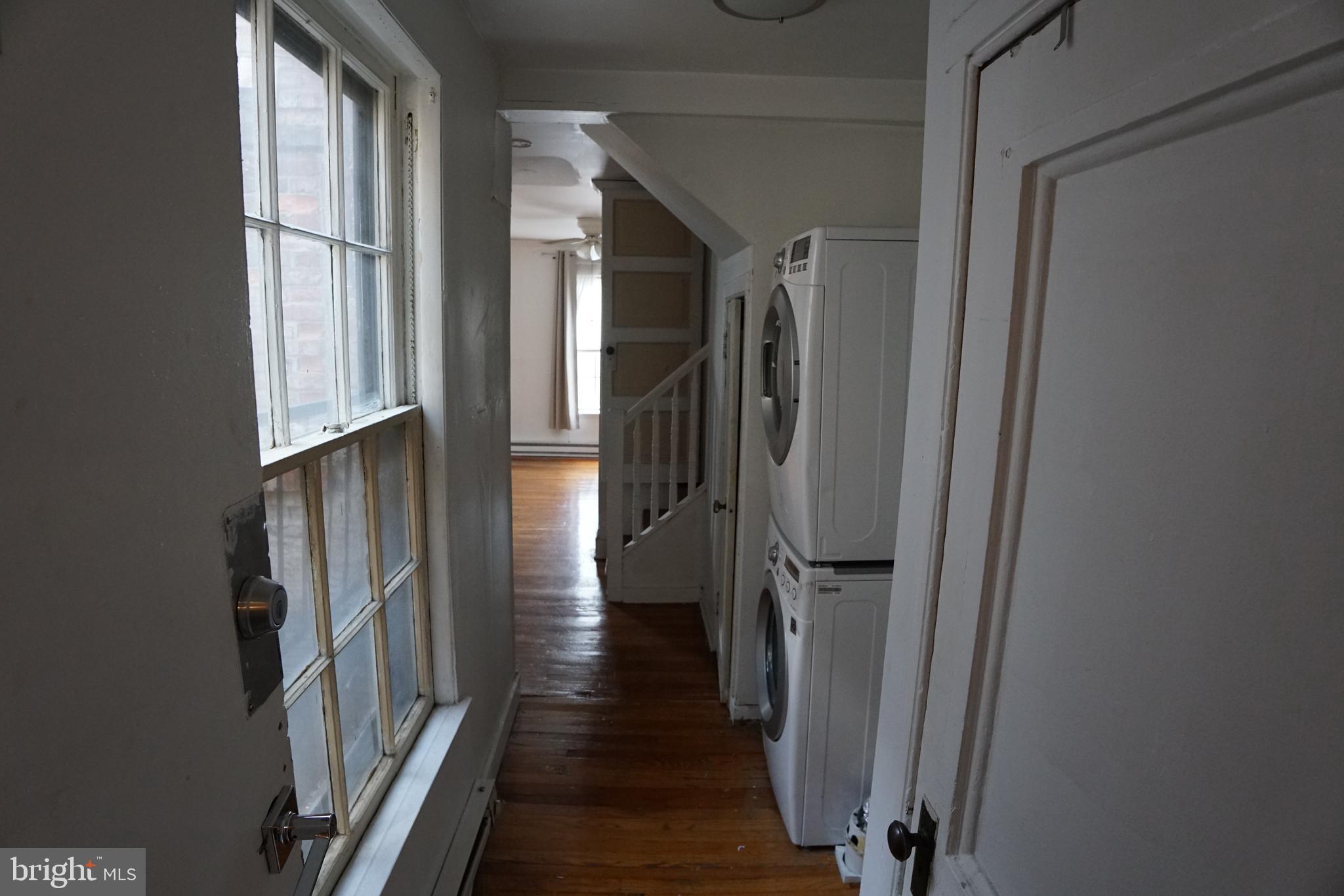802 Cathedral Street, Unit 4 Baltimore, MD 21201 - Photo 3 of 15 a view of a hallway with wooden floor and staircase