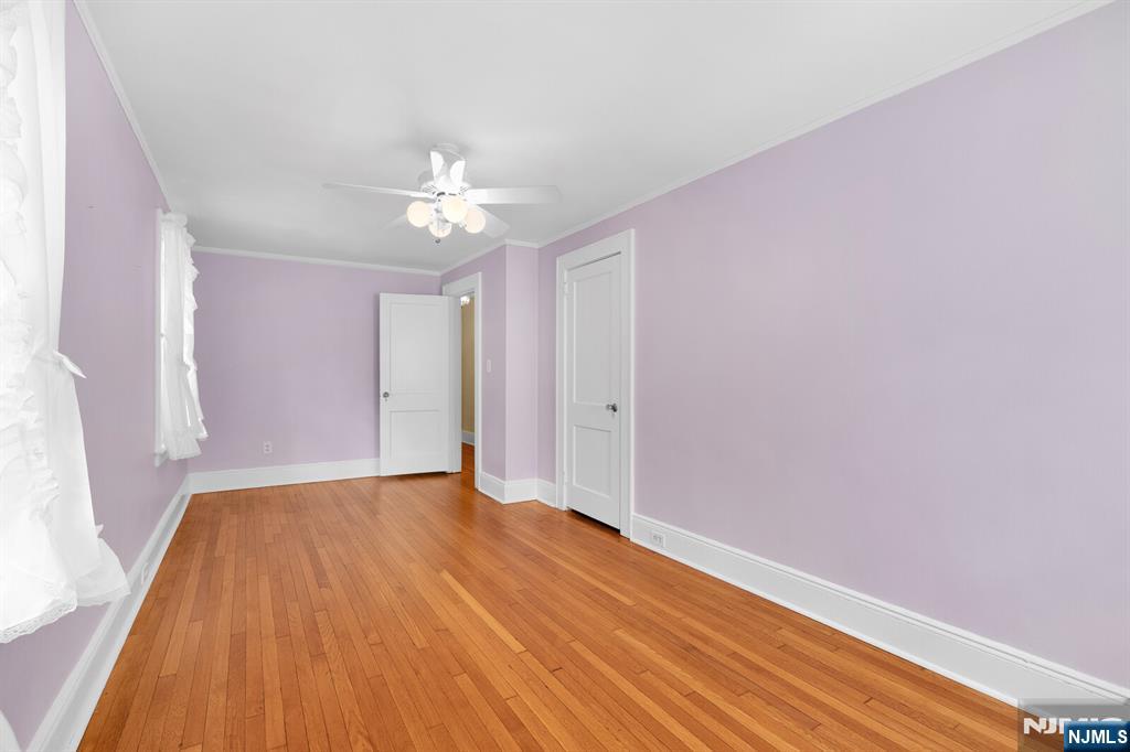 106 Maple Street Rutherford, NJ 07070 - Photo 31 of 50 wooden floor in an empty room with a window