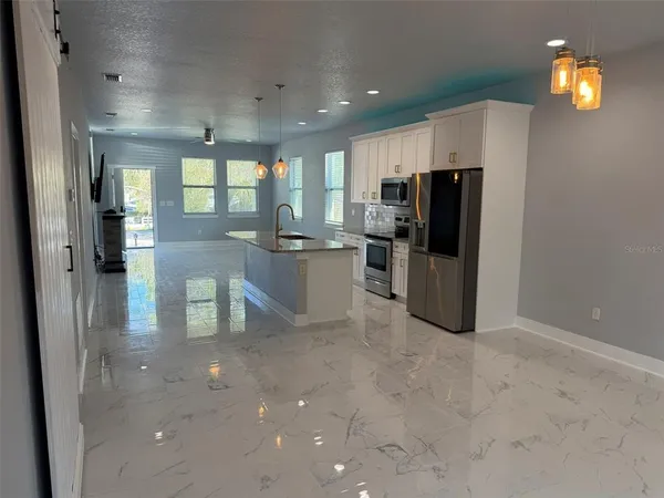 a kitchen with refrigerator and window
