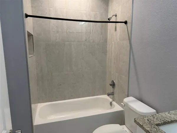 a bathroom with a toilet and a bathtub