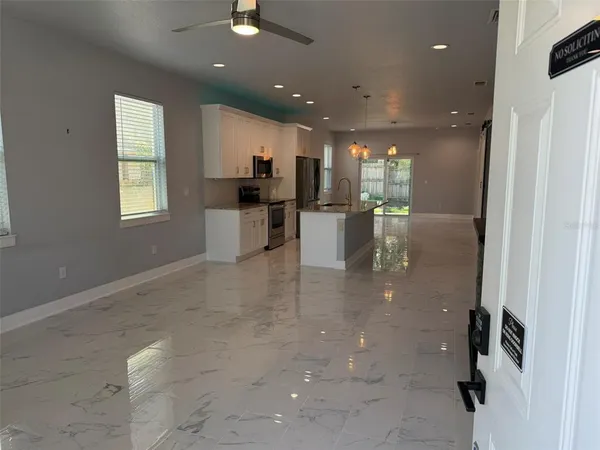 a view of kitchen with cabinets and window