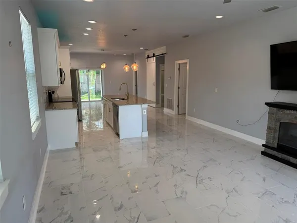 a view of kitchen with furniture and flat screen tv