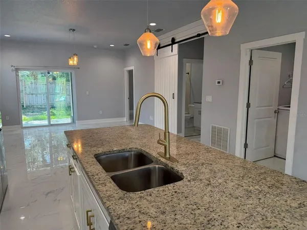 a kitchen with a sink and a refrigerator