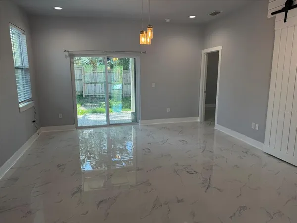 a view of an empty room with floor to ceiling windows