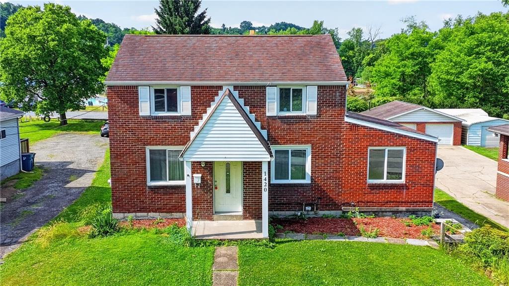 1420 Homestead Road Verona, PA 15147 - Photo 1 of 34 a front view of a house with a garden and plants
