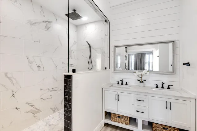 a bathroom with double vanity sink and a mirror