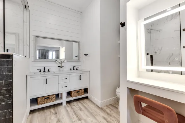 a bathroom with a sink vanity and mirror