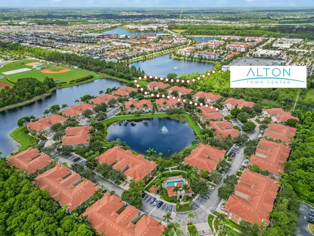 an aerial view of a city with lots of residential buildings lake and ocean view