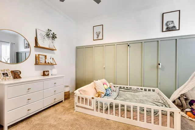 a bedroom with a bed and a chandelier