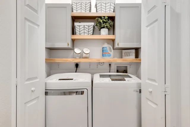 a view of washer and dryer with kitchen in the background