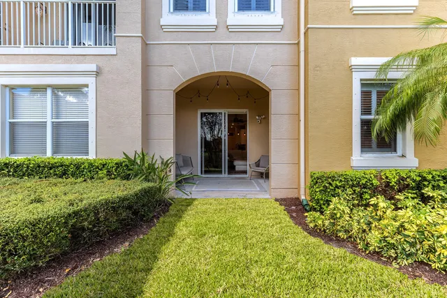 a view of front door of house and yard with green space