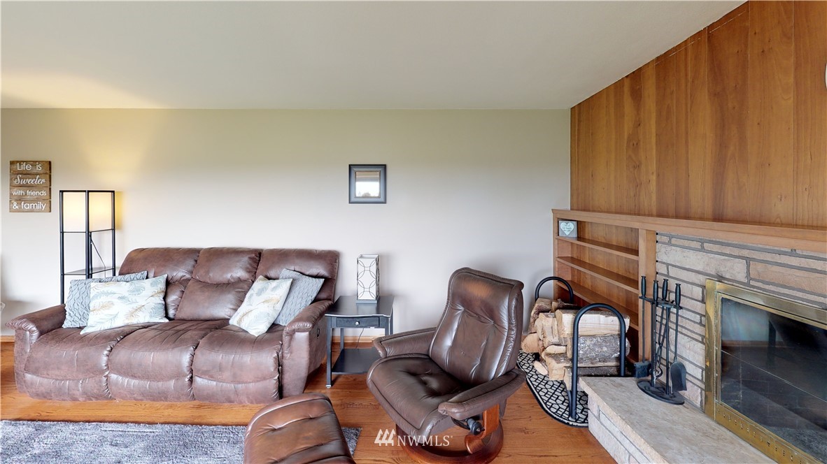 17307 Dunbar Road Mount Vernon, WA 98273 - Photo 4 of 22 a living room with furniture a fireplace and a wooden floor