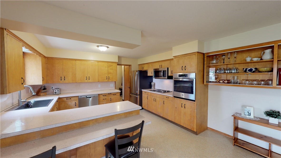 17307 Dunbar Road Mount Vernon, WA 98273 - Photo 6 of 22 a kitchen with stainless steel appliances granite countertop a sink and cabinets
