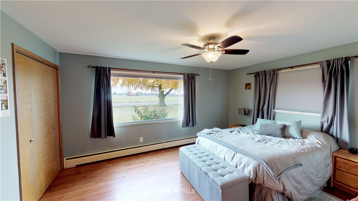 17307 Dunbar Road Mount Vernon, WA 98273 - Photo 9 of 22 a bedroom with a bed and a large window