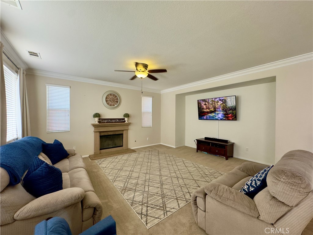 11265 Runyan Road Beaumont, CA 92223 - Photo 45 of 138 a living room with furniture and a chandelier