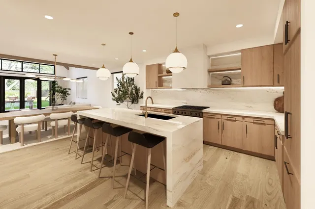a kitchen with a sink a counter top space and stainless steel appliances