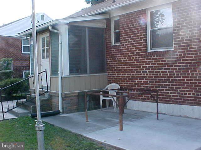 3617 Randolph Road Silver Spring, MD 20902 - Photo 3 of 16 a brick house with a bench and a yard