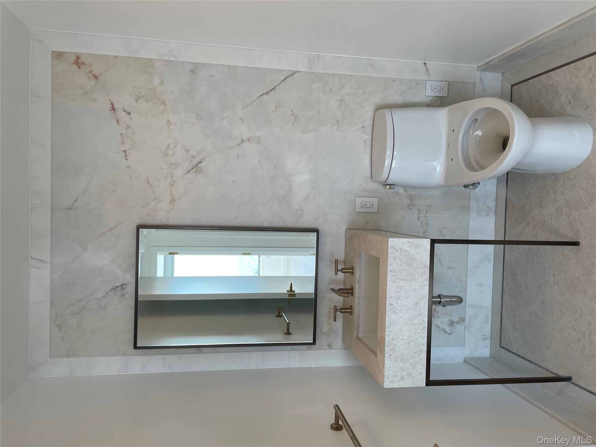 3 Court Square, Unit 5211 Queens, NY 11101 - Photo 11 of 13 a bathroom with a toilet sink and mirror