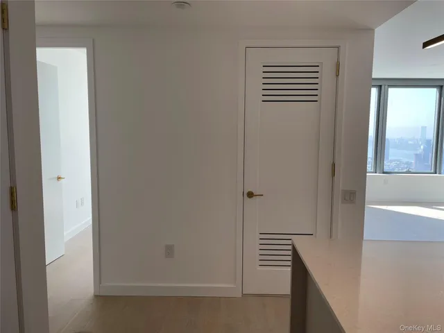 a view of room with window and wooden floor