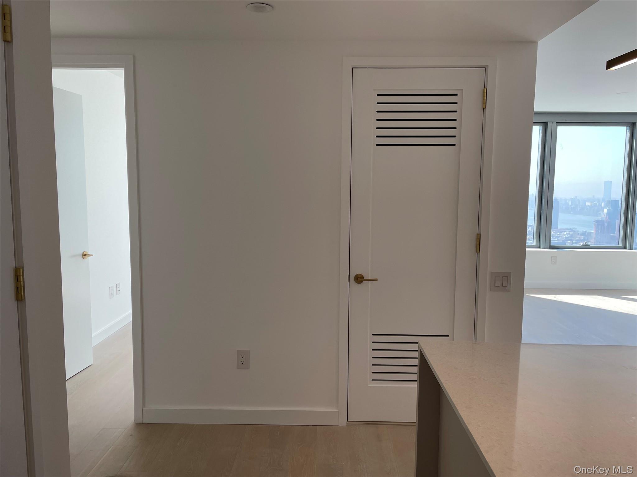 3 Court Square, Unit 5211 Queens, NY 11101 - Photo 12 of 13 a view of room with window and wooden floor