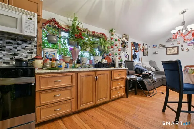 a view of a dining room with furniture and a kitchen