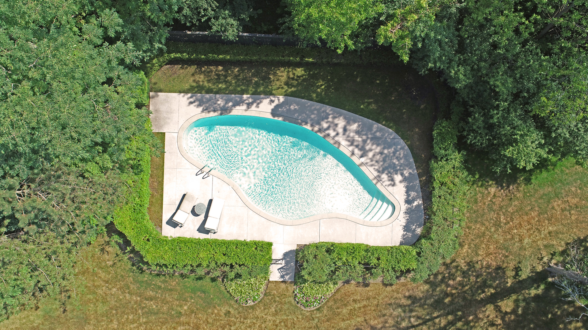 1035 North Sheridan Road Lake Forest, IL 60045 - Photo 44 of 47 an aerial view of a swimming pool with outdoor space and lake view in back
