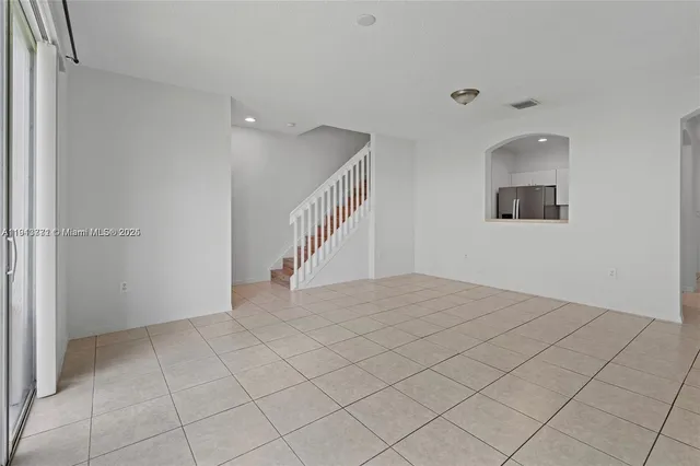 a view of an empty room and wooden floor