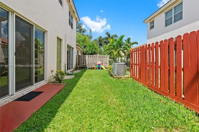 a view of a backyard with wooden fence