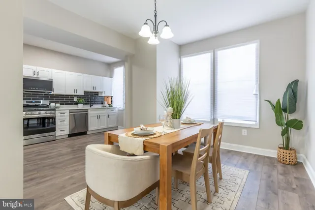 a living room with kitchen island furniture and a kitchen view