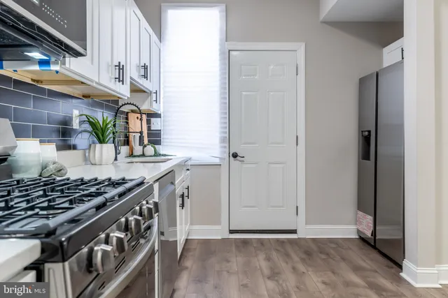 a kitchen with stainless steel appliances granite countertop a stove and a sink