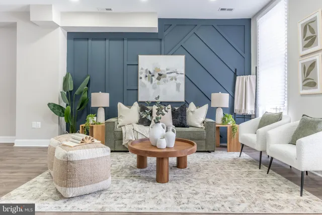 a living room with furniture and a potted plant