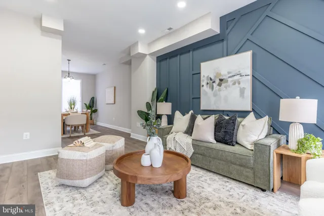 a living room with furniture and a potted plant