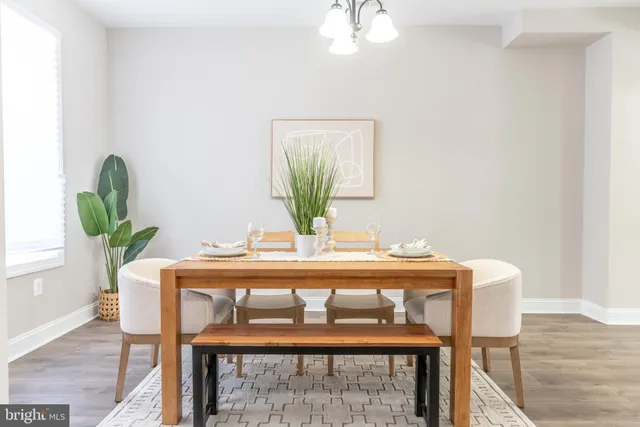 a dining room with furniture and wooden floor