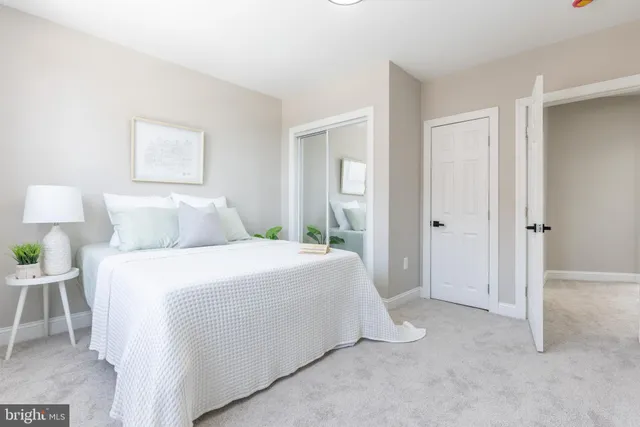 a bedroom with a bed and a lamp