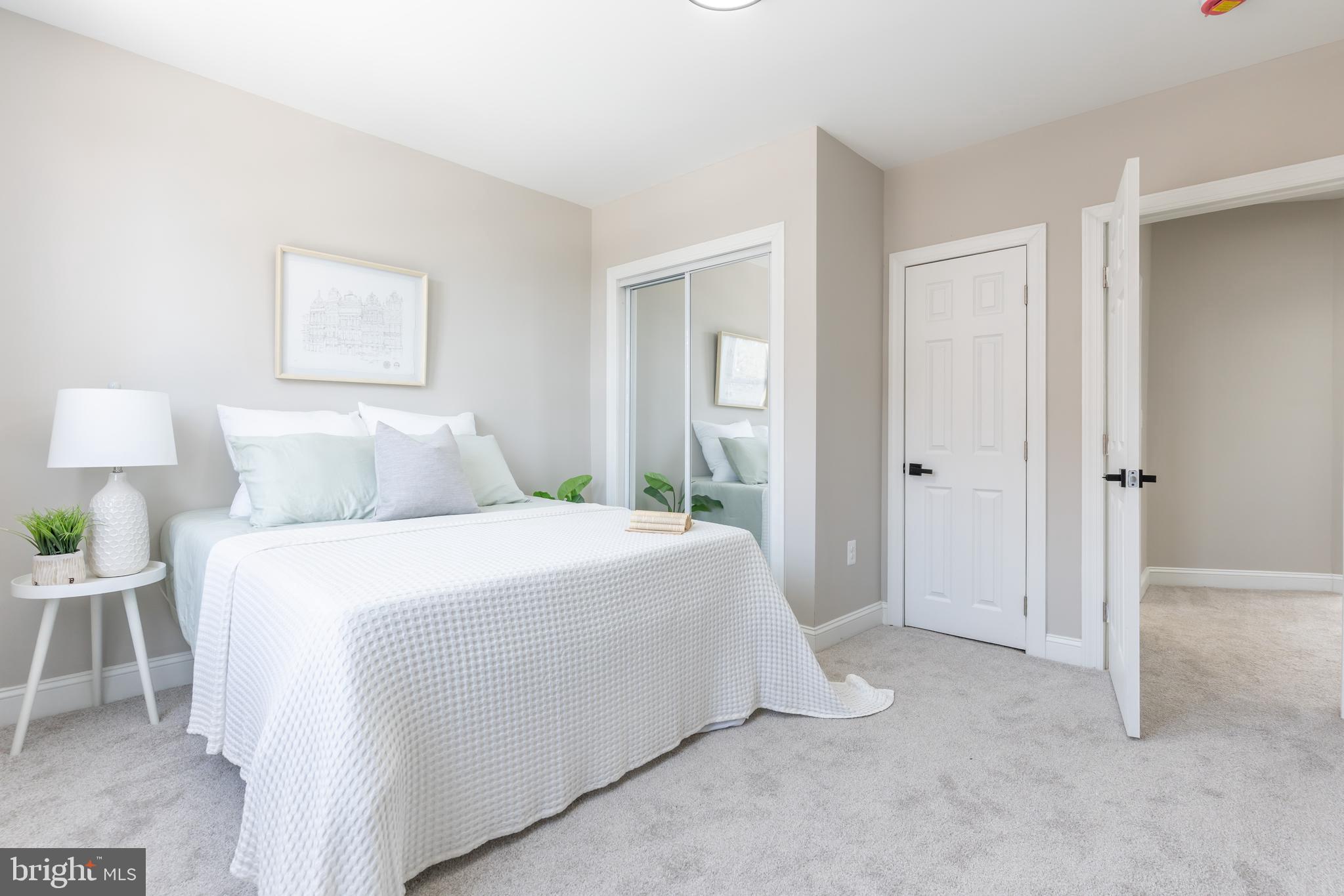 3651 Cottage Avenue Baltimore, MD 21215 - Photo 25 of 38 a bedroom with a bed and a lamp