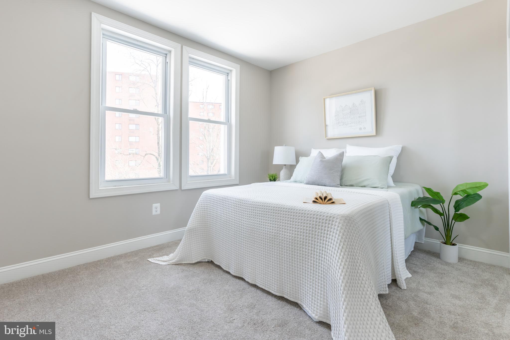 3651 Cottage Avenue Baltimore, MD 21215 - Photo 7 of 38 a bedroom with a bed and a potted plant