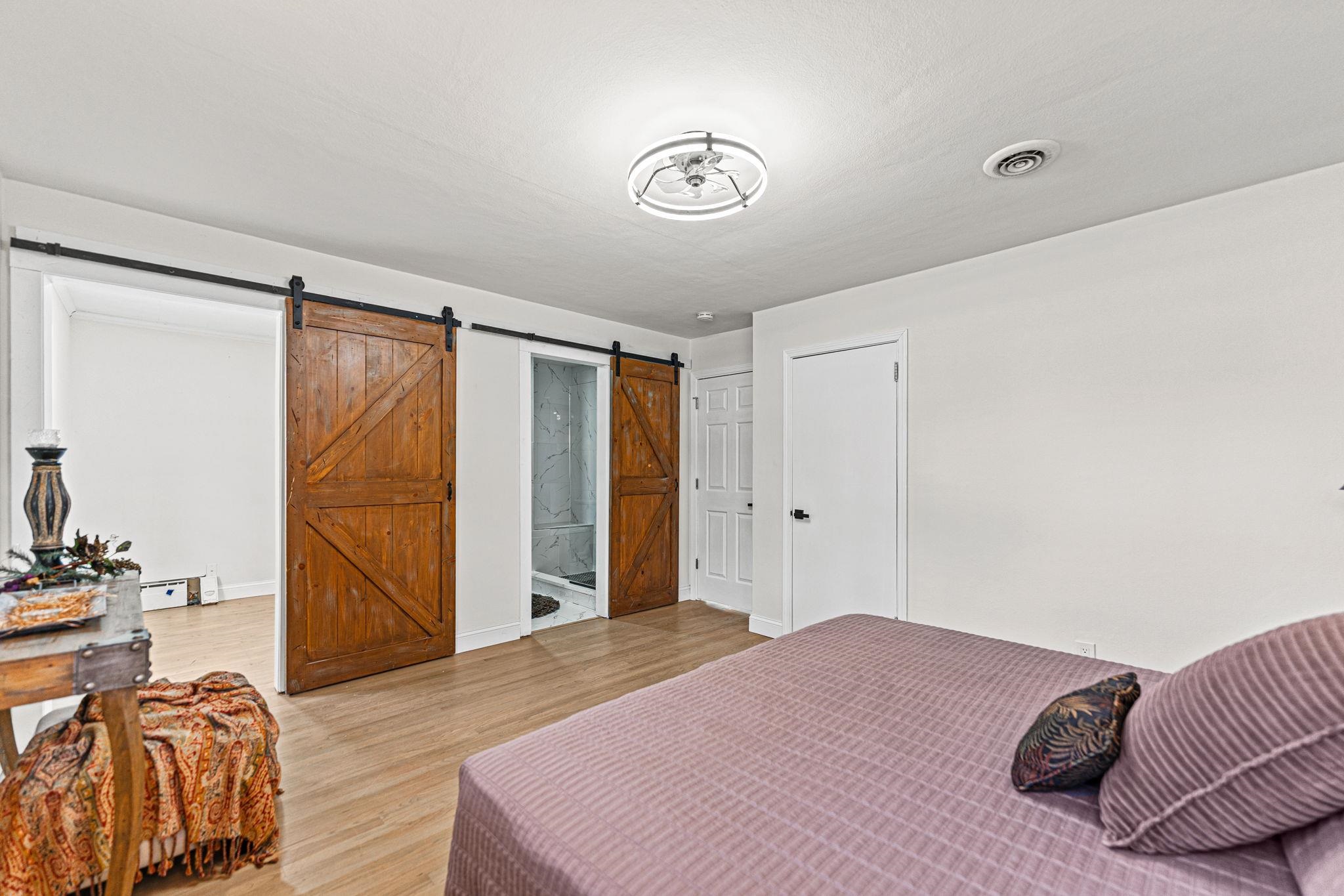 2915 Rural Street Rockford, IL 61107 - Photo 20 of 42 a bedroom with a bed and a chandelier