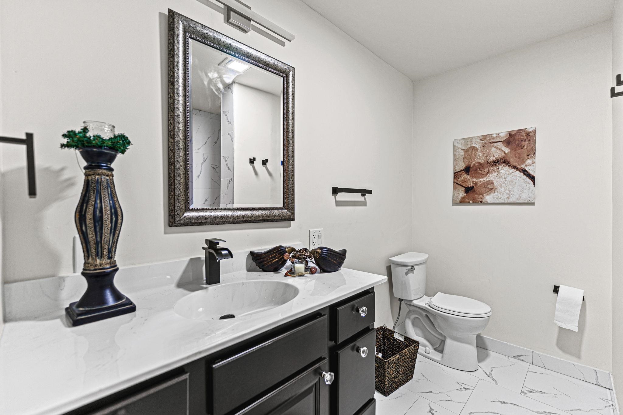 2915 Rural Street Rockford, IL 61107 - Photo 23 of 42 a bathroom with a toilet a sink and mirror