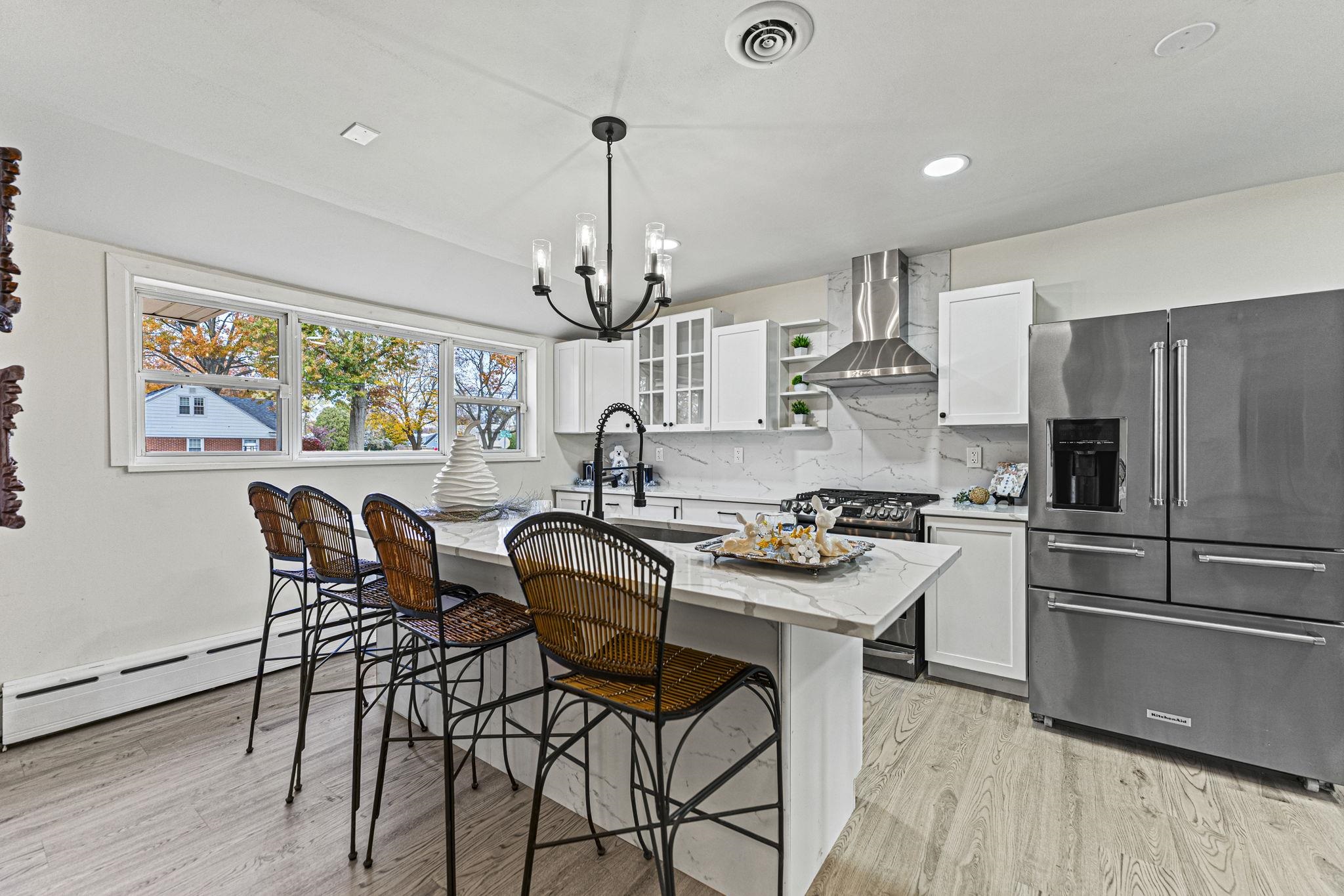2915 Rural Street Rockford, IL 61107 - Photo 5 of 42 a kitchen with stainless steel appliances kitchen island a table and chairs in it