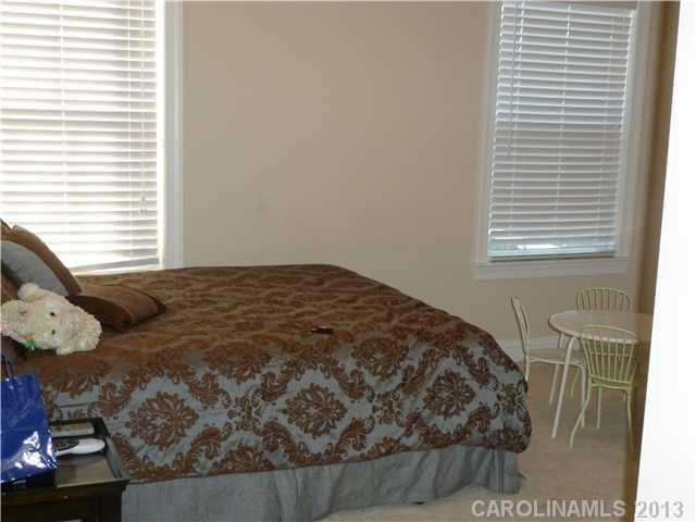 78059 Rillstone Drive Lancaster, SC 29720 - Photo 11 of 16 a bedroom with a bed and wooden floor