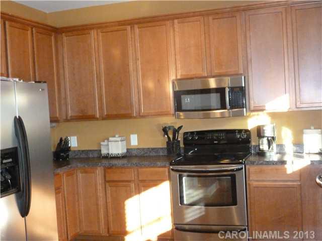 78059 Rillstone Drive Lancaster, SC 29720 - Photo 4 of 16 a kitchen with stainless steel appliances a stove a microwave a sink and cabinets