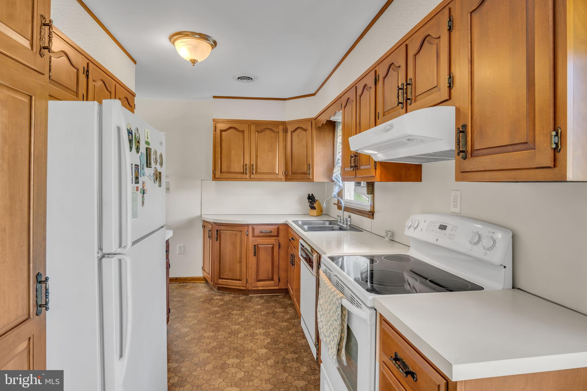 1325 Goodyear Road Gardners, PA 17324 - Photo 12 of 39 a kitchen with a sink a refrigerator and a stove