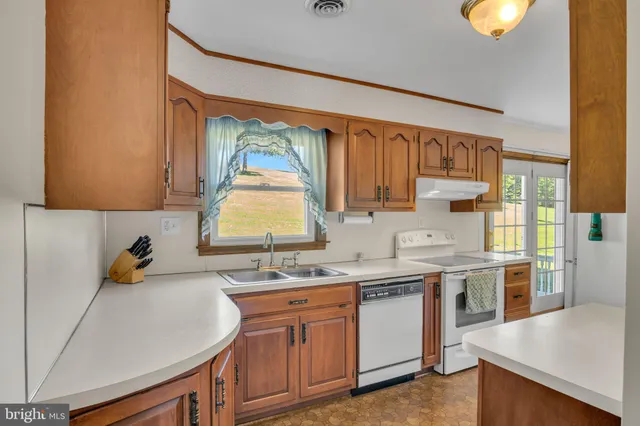 a kitchen with a sink cabinets and window