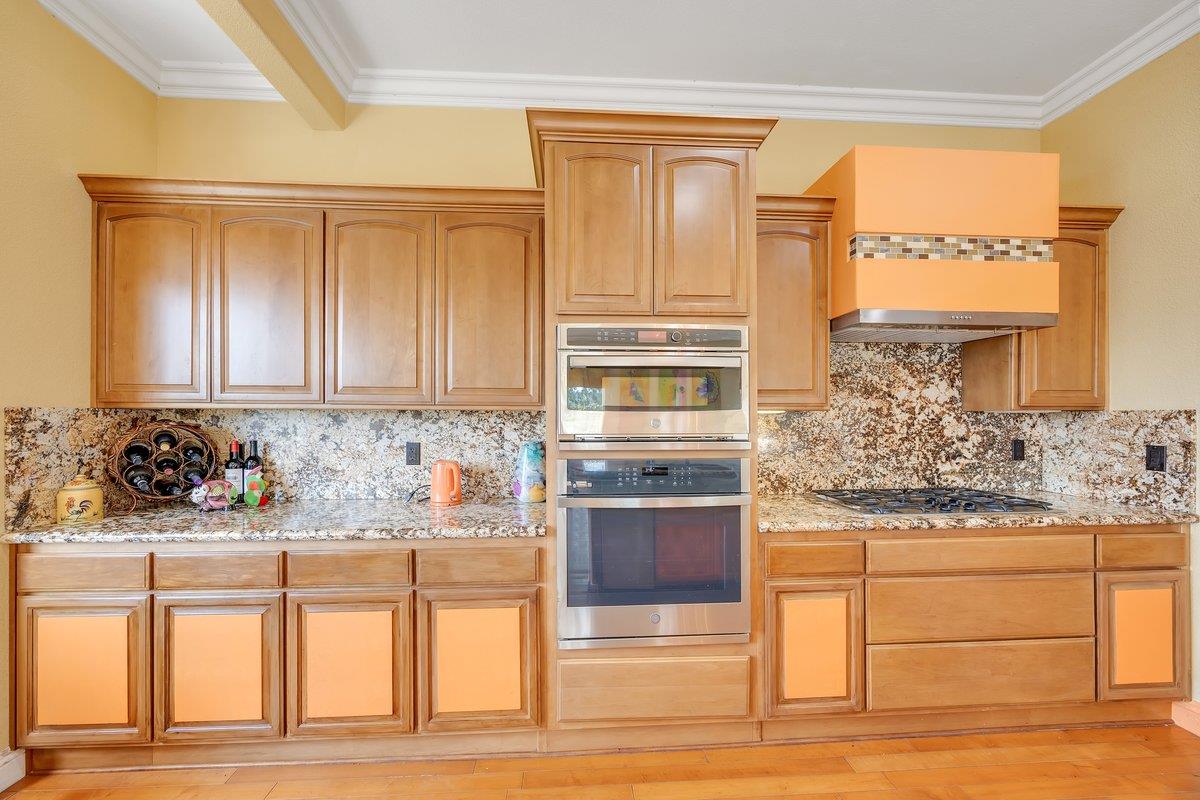 33 Aurora Lane Copperopolis, CA 95228 - Photo 13 of 46 kitchen featuring stainless steel appliances, light stone counters, crown molding, light wood-type flooring, and light wood finish cabinets