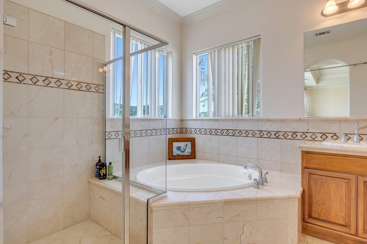 33 Aurora Lane Copperopolis, CA 95228 - Photo 24 of 46 bathroom with a shower stall, vanity, crown molding, a bath, and healthy amount of natural light