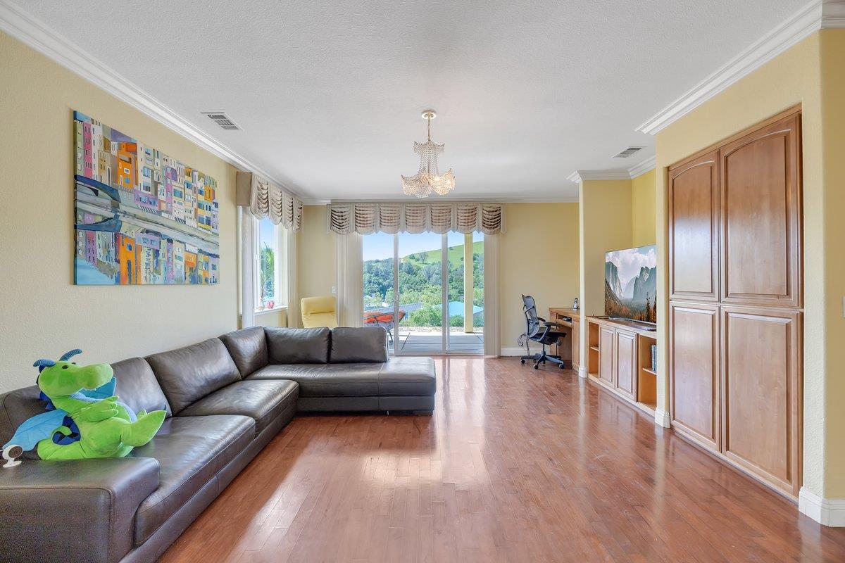 33 Aurora Lane Copperopolis, CA 95228 - Photo 30 of 46 living area featuring an office area, crown molding, light wood-style flooring, and suspended lighting